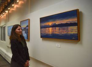 Mari Kanagy/Juneau Empire
Local artist Johanna Griggs looks at The Ocean Mirror, her favorite piece from her exhibit Landscapes of Southeast Alaska, on display at the Juneau Arts and Culture Center.
