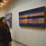 Local artist Johanna Griggs looks at The Ocean Mirror, her favorite piece from her exhibit Landscapes of Southeast Alaska, on display at the Juneau Arts and Culture Center. (Mari Kanagy/Juneau Empire)