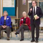 Juneau state Sen. Jesse Kiehl, standing, addresses a town hall audience Jan. 11 at Dzantiki Heeni Middle School as Juneau state Reps. Sarah Hannan, far left, and Andi Story wait their turn to discuss their priorities during the 2023 legislative session.(Mark Sabbatini / Juneau Empire file file)