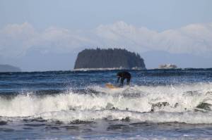 Surfer catches wave at Lena Cove. (Photo by Atticus Hempel/Juneau Empire)