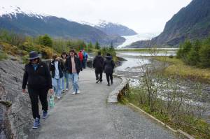 Photo by Yereth Rosen/Alaska Beacon 
Tourists walk to and from a viewpoint at the Mendenhall Glacier visitor center on May 14, 2025. The visitor center in the Tongass National Forest is a top tourist destination.