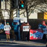 Ballot Measure 1 supporters wave signs for morning commuters at the corner of Egan Drive and 10th Street on Election Day, Tuesday, Nov. 6, 2018. (Michael Penn | Juneau Empire)